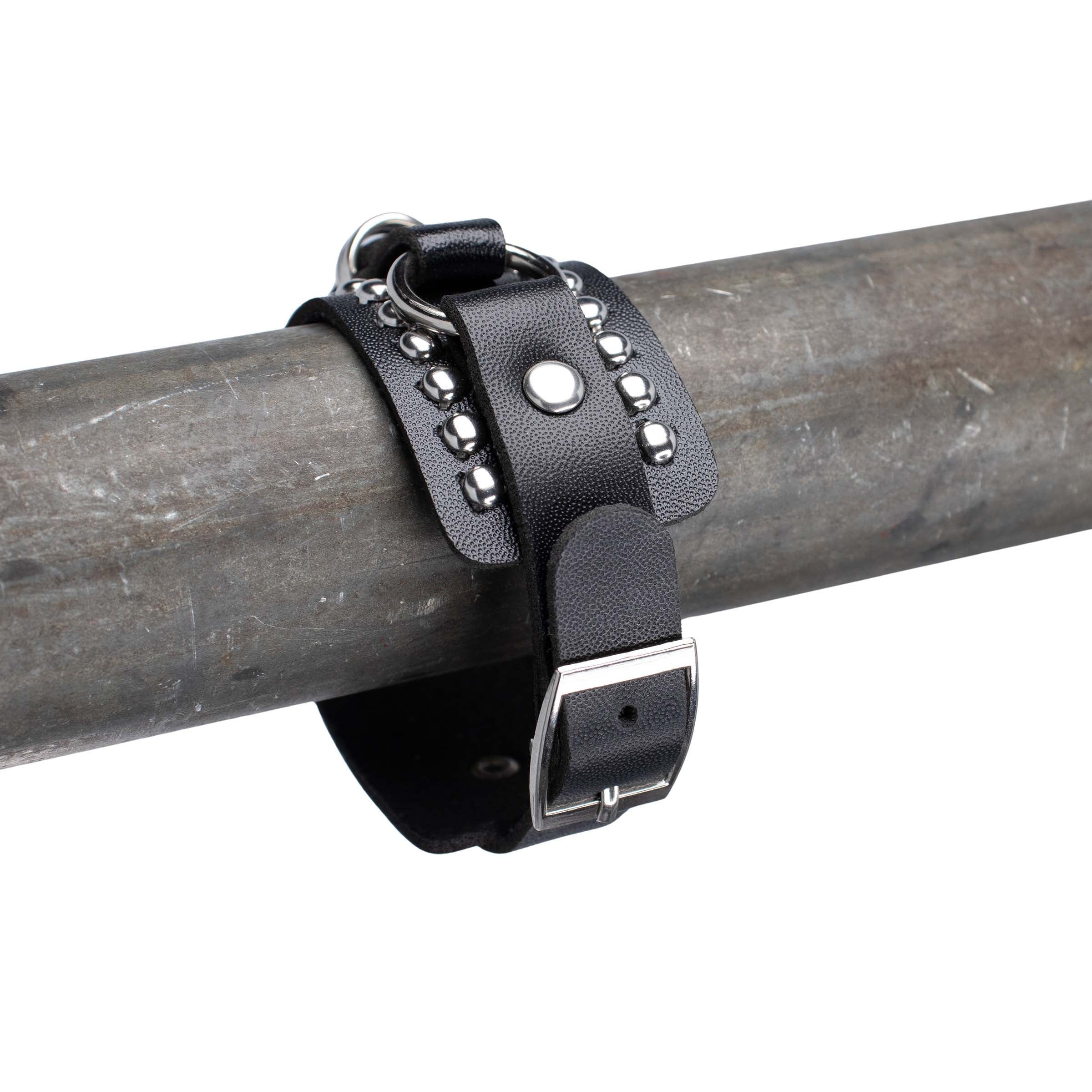 Close up achterzijde en sluiting van leren rave armband met zilveren studs.